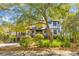 Charming home with brick accents, second-story porch, and a beautifully landscaped front yard at 3121 Marshgate Dr, Johns Island, SC 29455