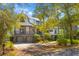 Charming home showcasing meticulously maintained landscaping, a brick driveway, and a welcoming facade at 3121 Marshgate Dr, Johns Island, SC 29455