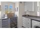 Laundry room with built-in wine fridge, counters, cabinets, and a modern washer and dryer at 3121 Marshgate Dr, Johns Island, SC 29455