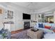 Bright living room features a fireplace, built-in shelving, and cozy seating arrangement at 3121 Marshgate Dr, Johns Island, SC 29455
