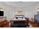 Charming main bedroom features hardwood floors, plantation shutters, and a decorative accent chest at the foot of the bed at 3121 Marshgate Dr, Johns Island, SC 29455