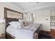 Inviting main bedroom highlighting a leather bed, neutral tones, and a glimpse into a walk-in closet at 3121 Marshgate Dr, Johns Island, SC 29455
