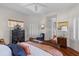 Spacious main bedroom features hardwood floors and multiple windows with views of the yard and a decorative writing desk at 3121 Marshgate Dr, Johns Island, SC 29455