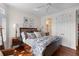 Relaxing main bedroom featuring a cozy queen-sized bed, hardwood floors, and an en suite bathroom at 3121 Marshgate Dr, Johns Island, SC 29455