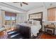 A stylish main bedroom with a balcony overlooking the waterfront, offering serene views and a relaxing ambiance at 3121 Marshgate Dr, Johns Island, SC 29455
