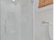 Modern shower with seamless glass door and towel hooks features white subway tile and a built in shelf at 3121 Marshgate Dr, Johns Island, SC 29455