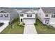 An attractive home boasts a manicured lawn, a double garage, and is nestled in a peaceful neighborhood at 315 Black Birch Dr, Summerville, SC 29486