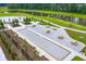 Aerial view of a bocce ball court with picnic tables and seating areas beside a lake at 315 Black Birch Dr, Summerville, SC 29486