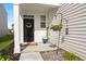 Inviting front porch with a decorative wreath, potted plants, and a welcome sign, exuding curb appeal at 315 Black Birch Dr, Summerville, SC 29486