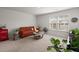 Bright living room features a cozy couch, plants, and large window at 315 Black Birch Dr, Summerville, SC 29486