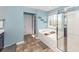 Bathroom showcasing a glass-enclosed shower, soaking tub, tile floors, and blue walls with natural light at 327 Freeland Way, Moncks Corner, SC 29461
