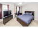 Bedroom featuring a bed, a desk with chair, a television, and two windows with natural light at 327 Freeland Way, Moncks Corner, SC 29461