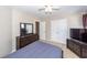 Cozy bedroom with ceiling fan, dresser, and mounted television at 327 Freeland Way, Moncks Corner, SC 29461