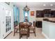 Cozy breakfast nook with wooden table, pendant lighting, and access to the kitchen at 327 Freeland Way, Moncks Corner, SC 29461