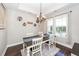 Bright dining room with modern chandelier, hardwood floors, and large windows at 327 Freeland Way, Moncks Corner, SC 29461
