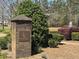 Community entrance sign showcasing a lush landscape and a serene pond at 327 Freeland Way, Moncks Corner, SC 29461