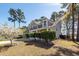 Charming two-story home with a well-manicured lawn, mature trees, and a welcoming front porch at 327 Freeland Way, Moncks Corner, SC 29461