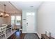 Home entry featuring a white door, hardwood floors, natural light, and adjacent dining area at 327 Freeland Way, Moncks Corner, SC 29461
