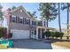 Two-story home featuring a manicured front yard and covered front porch at 327 Freeland Way, Moncks Corner, SC 29461