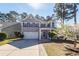 Charming two-story home featuring a manicured front yard and covered front porch at 327 Freeland Way, Moncks Corner, SC 29461