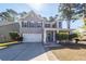 Charming two-story home showcasing a manicured front yard and covered porch at 327 Freeland Way, Moncks Corner, SC 29461