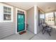Inviting front porch features a teal front door, neutral siding, and comfortable seating at 327 Freeland Way, Moncks Corner, SC 29461