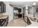 Well-appointed kitchen with granite countertops, stainless steel appliances, and dark wood cabinetry at 327 Freeland Way, Moncks Corner, SC 29461