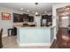 Charming kitchen with stainless steel appliances, granite countertops, dark wood cabinets, and an open layout at 327 Freeland Way, Moncks Corner, SC 29461