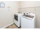 Bright laundry room features a new washer and dryer, with storage shelving at 327 Freeland Way, Moncks Corner, SC 29461
