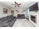Inviting living room showcases a fireplace, neutral walls, ceiling fan, and plush gray sofa at 327 Freeland Way, Moncks Corner, SC 29461