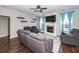 Inviting living room features a fireplace, ceiling fan, hardwood floors, and comfortable seating at 327 Freeland Way, Moncks Corner, SC 29461