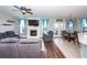 Cozy living room with stone fireplace, ceiling fan, hardwood floors, and comfortable seating at 327 Freeland Way, Moncks Corner, SC 29461