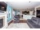 Open-concept living room featuring a fireplace, hardwood floors, and seamless access to the kitchen at 327 Freeland Way, Moncks Corner, SC 29461