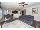 Comfortable living room with gray furniture, hardwood floors, ceiling fan, and an open view to the kitchen at 327 Freeland Way, Moncks Corner, SC 29461