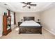 The primary bedroom features a tray ceiling, ceiling fan, a large bed and side tables, and bright natural light at 327 Freeland Way, Moncks Corner, SC 29461