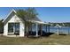 Community pavilion with picnic tables and grill overlooking a scenic lake on a sunny day at 327 Freeland Way, Moncks Corner, SC 29461