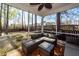 Enjoy relaxing on the screened porch with cozy seating and views of the backyard at 327 Freeland Way, Moncks Corner, SC 29461
