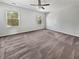 Spacious bedroom with neutral carpet, ample natural light from two windows, and a ceiling fan at 359 Dunlin Dr, Summerville, SC 29486