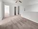 Spacious bonus room with neutral carpet, ample natural light, and ceiling fan; perfect for entertaining guests at 359 Dunlin Dr, Summerville, SC 29486