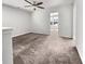 Bright bonus room with neutral walls and carpet, ceiling fan, and adjacent room access; perfect for an office at 359 Dunlin Dr, Summerville, SC 29486