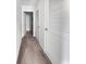 Hallway featuring carpeted floors and white doors, including closet space and laundry access; plenty of storage space at 359 Dunlin Dr, Summerville, SC 29486