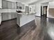 Kitchen boasts gray cabinets, granite countertops, stainless steel appliances, and hardwood flooring at 359 Dunlin Dr, Summerville, SC 29486