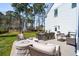 Outdoor patio with elegant dining and seating furniture nestled in a well-maintained backyard at 3858 Sawyers Island Dr, Mount Pleasant, SC 29466
