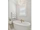 Bright bathroom features a standalone tub with gold fixtures and a decorative chandelier at 3858 Sawyers Island Dr, Mount Pleasant, SC 29466