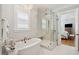 Luxurious bathroom featuring a soaking tub, glass shower with rain head, and elegant fixtures at 3858 Sawyers Island Dr, Mount Pleasant, SC 29466