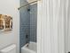 Bathroom featuring blue subway tiles, a shower-tub combo, and unique decor at 3858 Sawyers Island Dr, Mount Pleasant, SC 29466