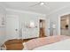 Light and airy bedroom with hardwood floors, ceiling fan, white dresser, and ensuite bathroom at 3858 Sawyers Island Dr, Mount Pleasant, SC 29466