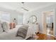 Bright bedroom with hardwood floors, white furnishings and a gray throw blanket at 3858 Sawyers Island Dr, Mount Pleasant, SC 29466