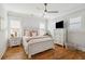 Cozy bedroom with white furniture, hardwood floors, ceiling fan, and plenty of natural light at 3858 Sawyers Island Dr, Mount Pleasant, SC 29466