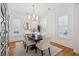 Dining room with white walls, modern chandelier, wood floors and plantation shutters at 3858 Sawyers Island Dr, Mount Pleasant, SC 29466